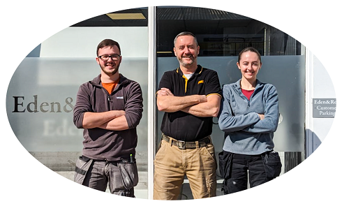 Two male and female standing outside a business